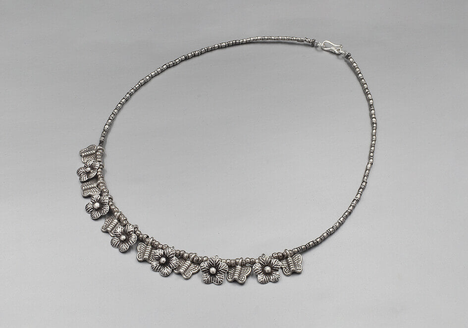 Silver necklace with butterfly and flower silver charms from Hill to Street