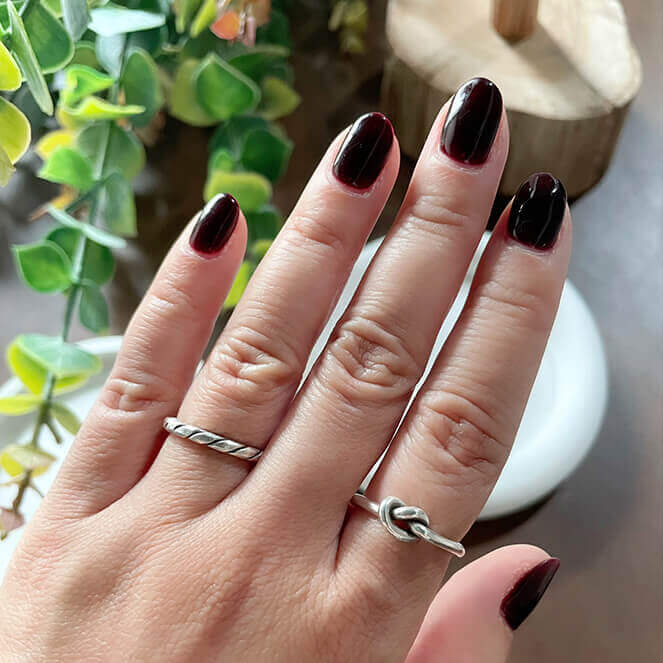 Zoomed-in photo of a model wearing a minimalist knot ring from Hill to Street